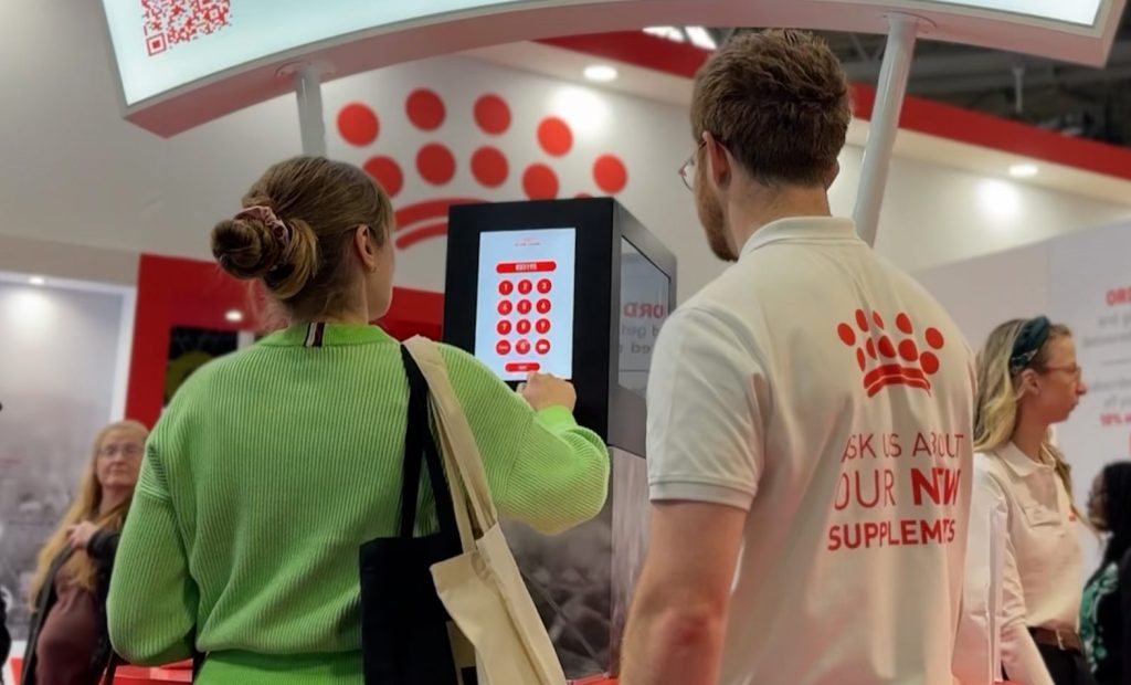 Woman entering her code into the Noonah Prize Vault at the Royal Canin stand during Crufts.