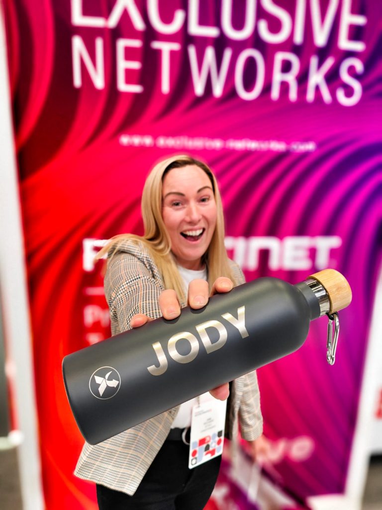 Guest holding a personalised custom engraved water bottle with her name, showcasing custom event engraving