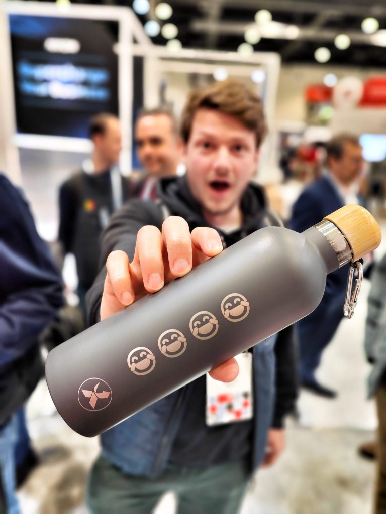 Guest holding a personalised engraved water bottle with laugh emojis at a live event engraving station