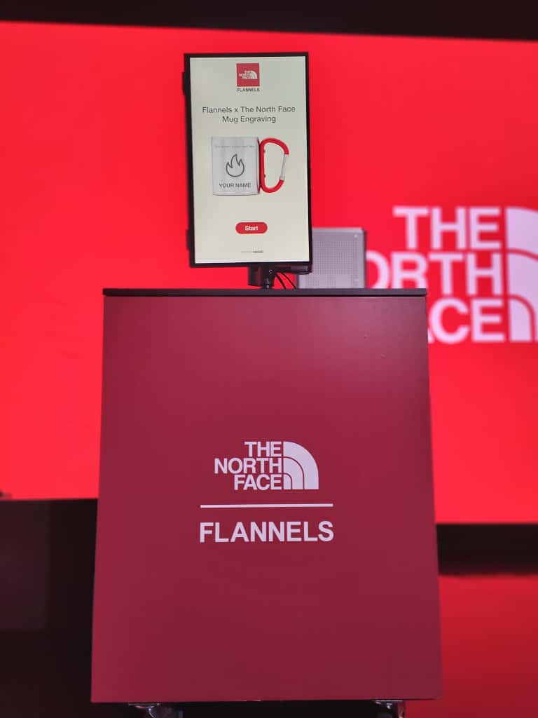 Personalised engraved travel mug on design station at The North Face x Flannels event