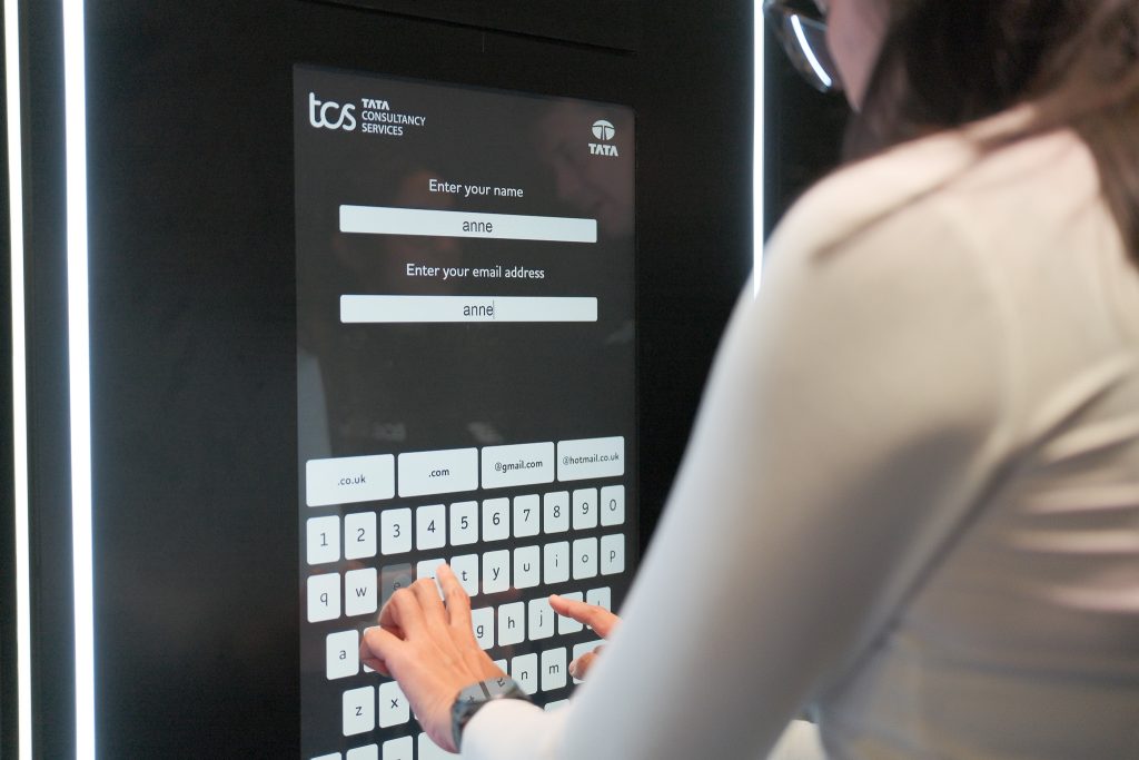 Girl inputting data into ai photo booth at london marathon