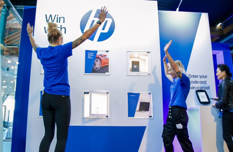 Guest celebrating a win at our interactive Prize Wall at the AI Summit.