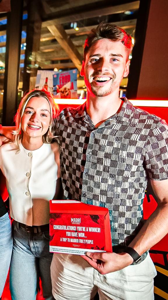 Guest celebrating winning the grand prize at the Noonah Prize Wall during the Madri Exceptional Summer Tour.