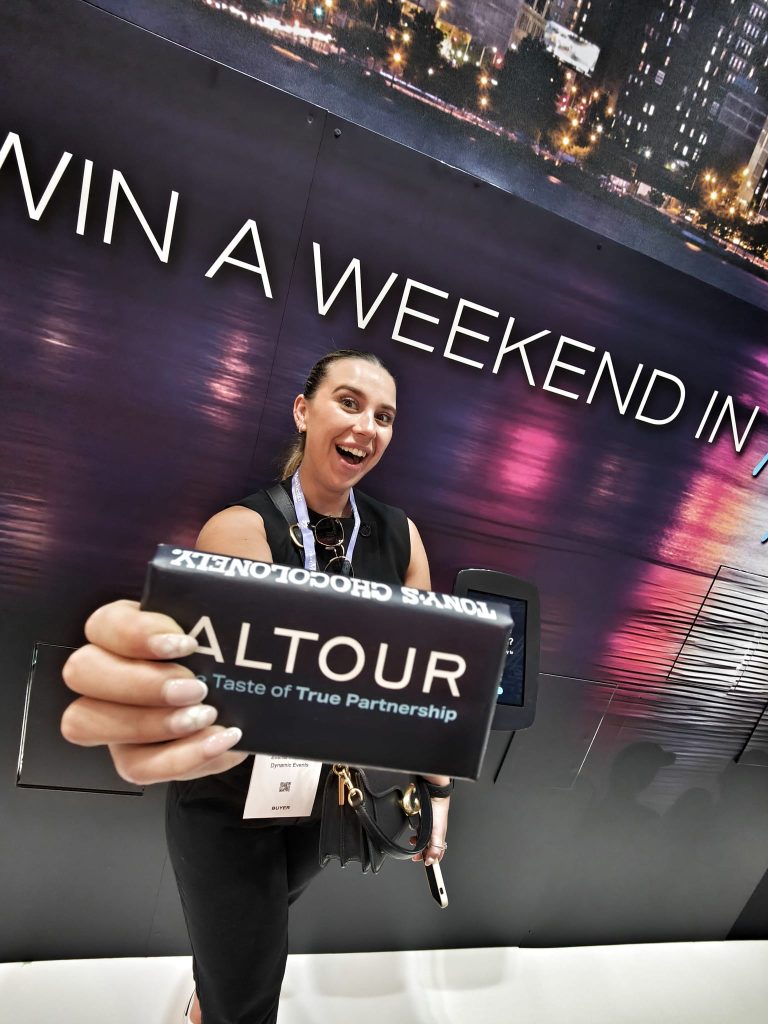 Guest at the Altour event showing off their prize from the Prize Wall.