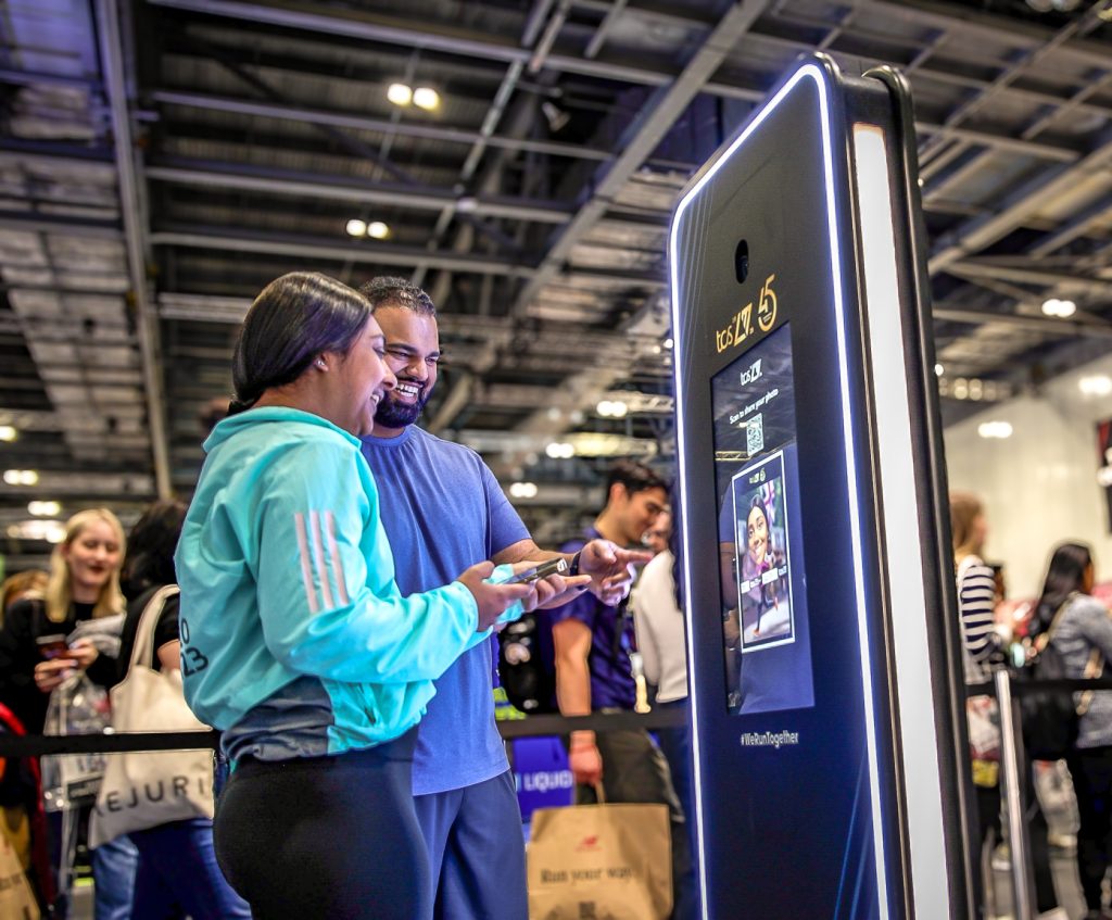couple using AI photo booth at London Marathon Running Show
