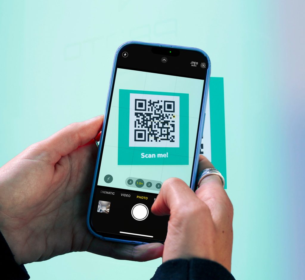 AI Pocket Booth image showing a guest scanning a QR code on their phone to start the AI Pocket Booth experience.