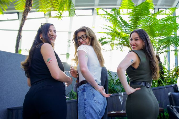 3 women in london sky garden wearing ai generated tattoos