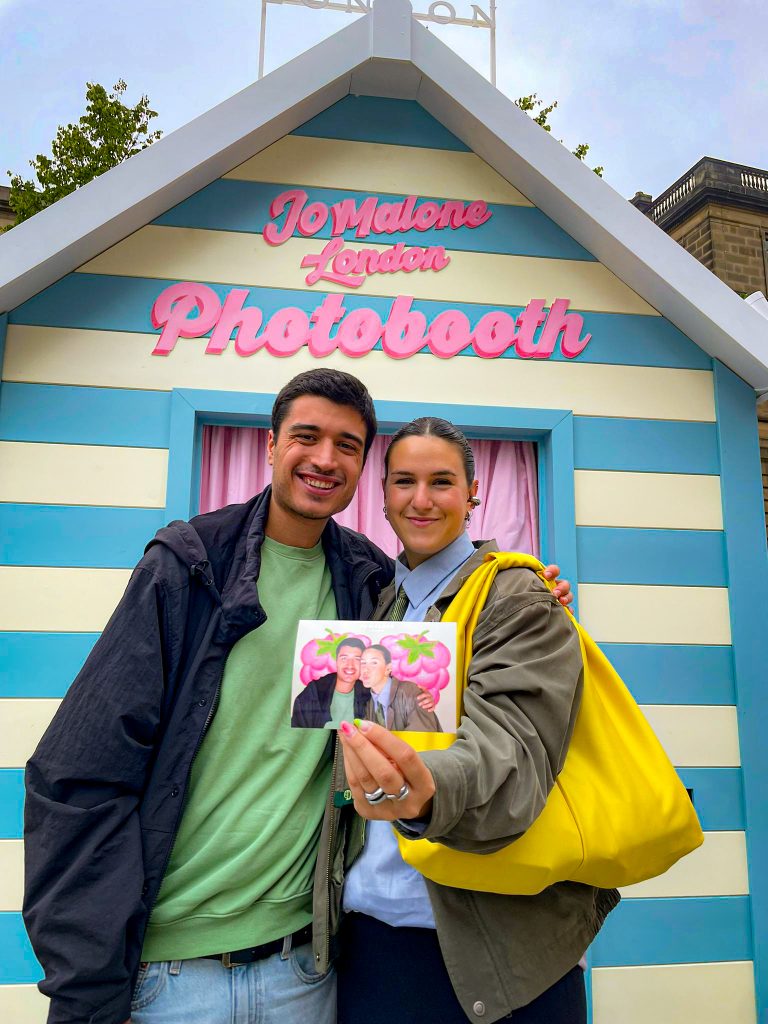Couple showing their printed photo from the Jo Malone branded photo booth