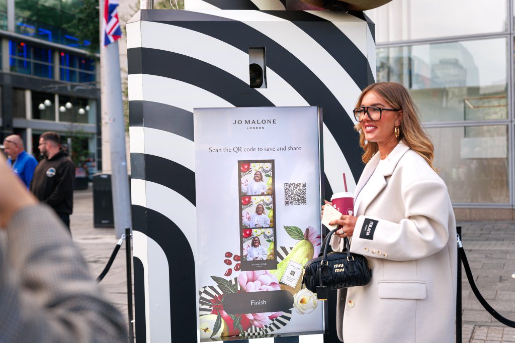 Woman using vending machine at Jo Malone brand event