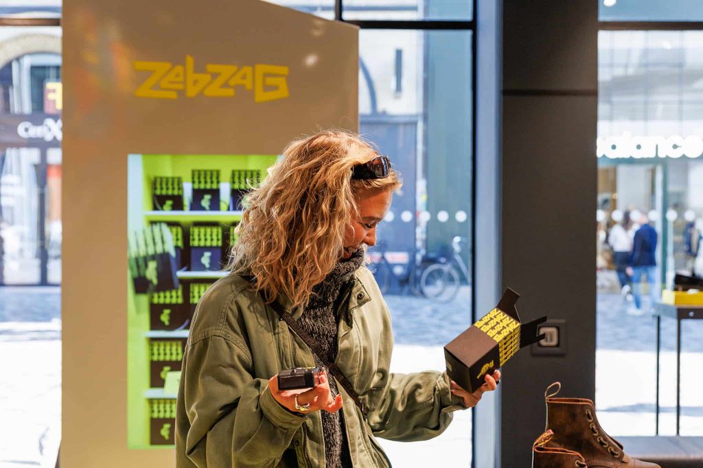 Girl holding vended gift in front of Dr Martens vending machine