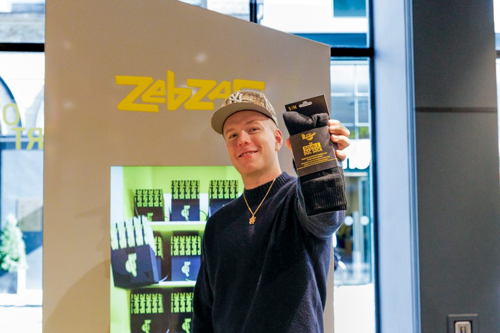 man stood in fromt of dr martens branded vending machine