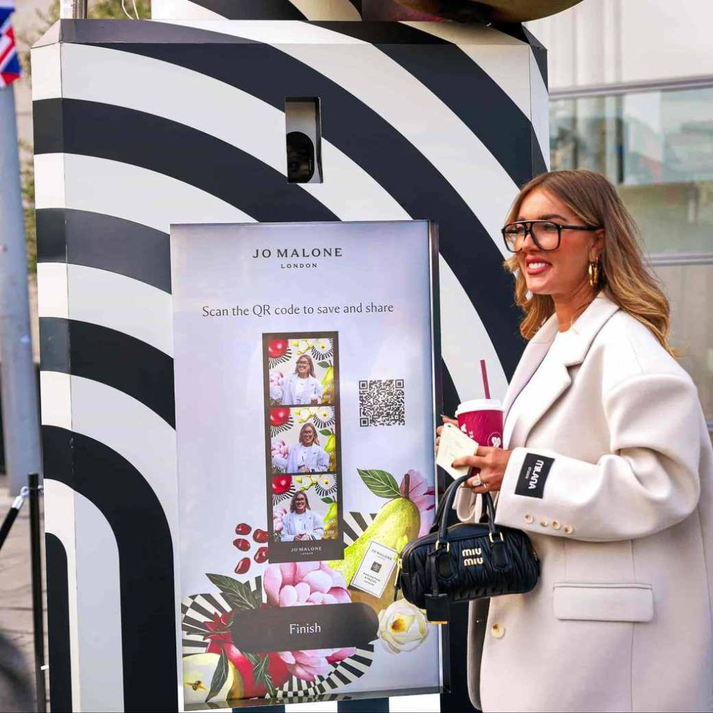 girl stood in front of Jo malone photo capture Vending Machine