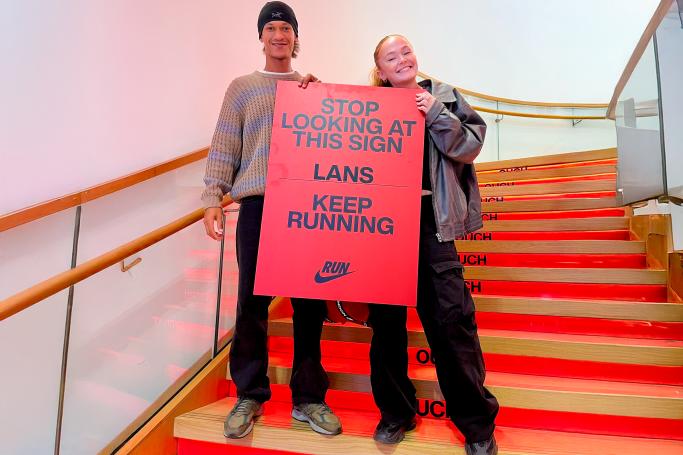 two people holding up personalised sign at Nike Town brand event