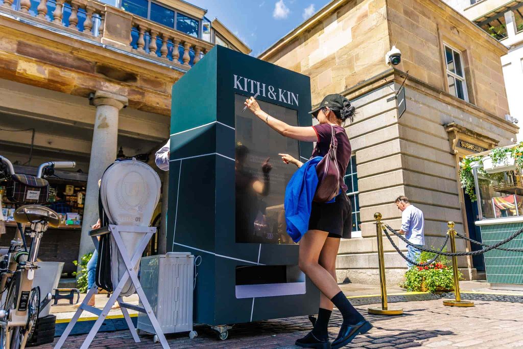 Girl using vending machine at Kith and Kin brand activation in London