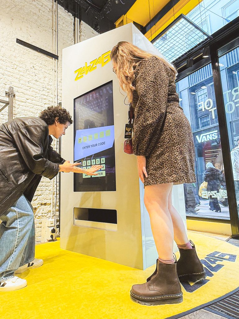 Woman using vending machine in retail space