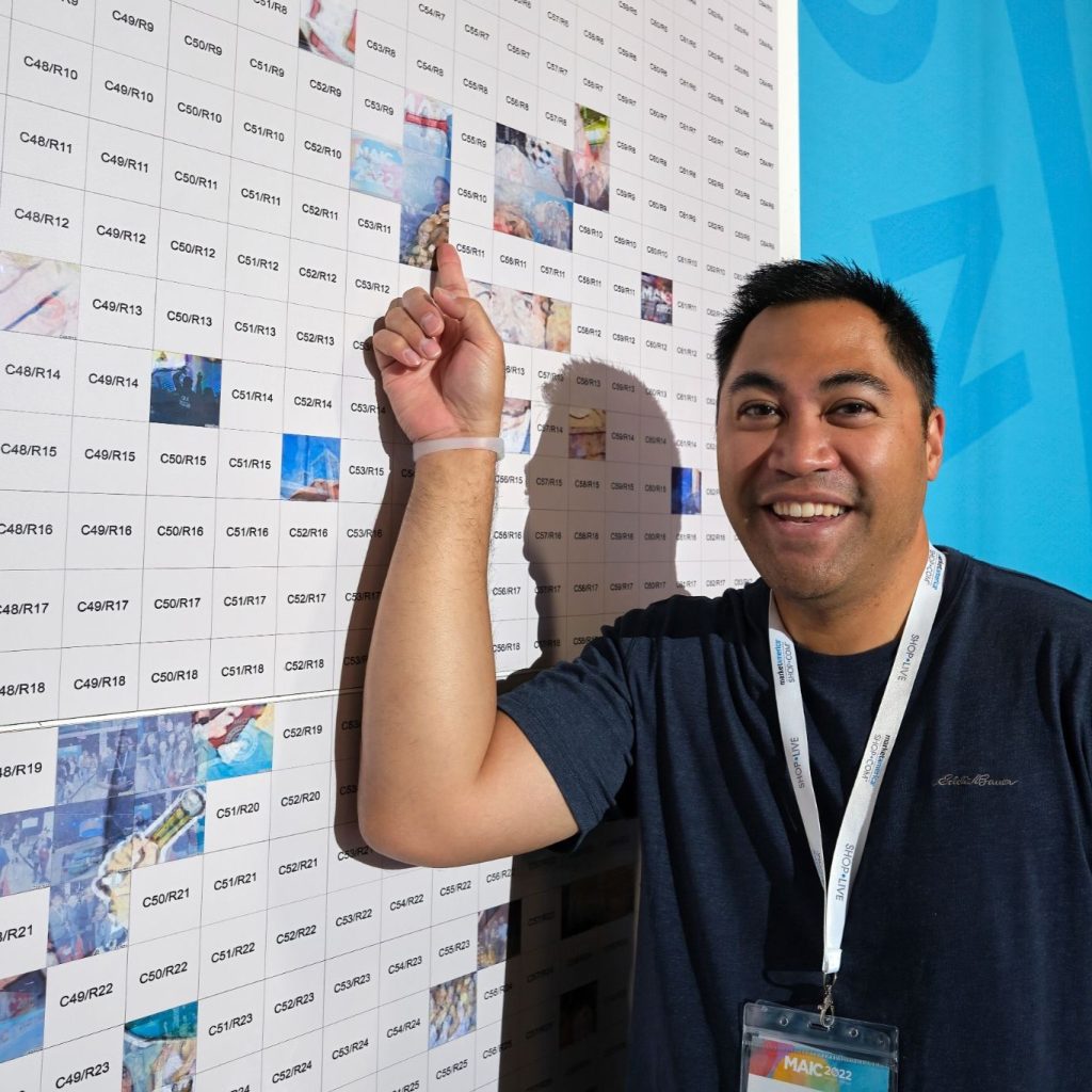 Man pointing at his Photo Mosaic Wall tile