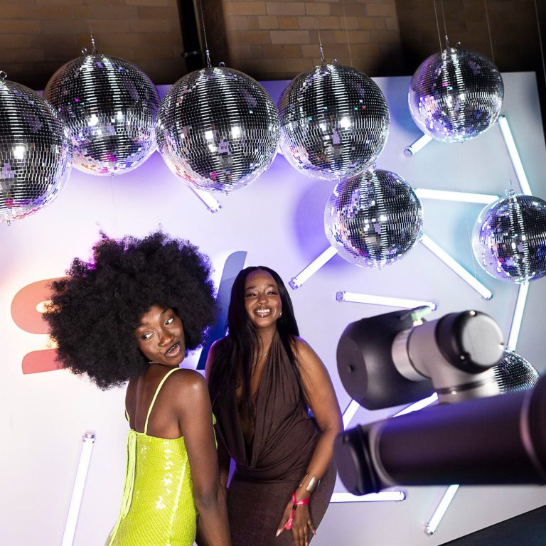 Two Women Posing for Glambot at the SKy Ball