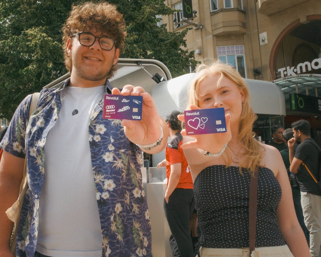 two people posing with personalised revolut debit cards