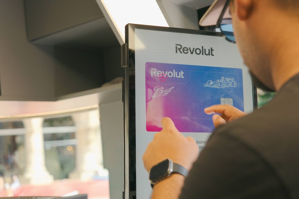 man designing his own revolut card at design station