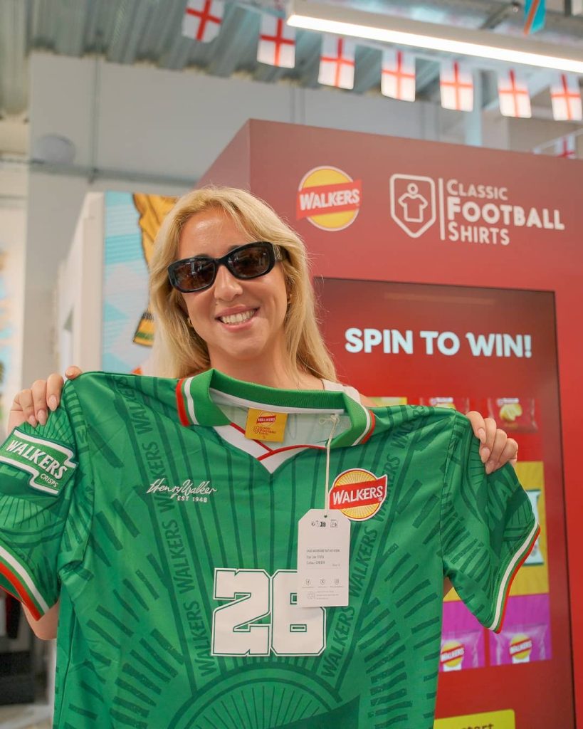 Prize Winner showing off the football shirt they won from the vending machine